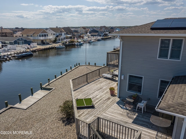 view of dock featuring a deck with water view