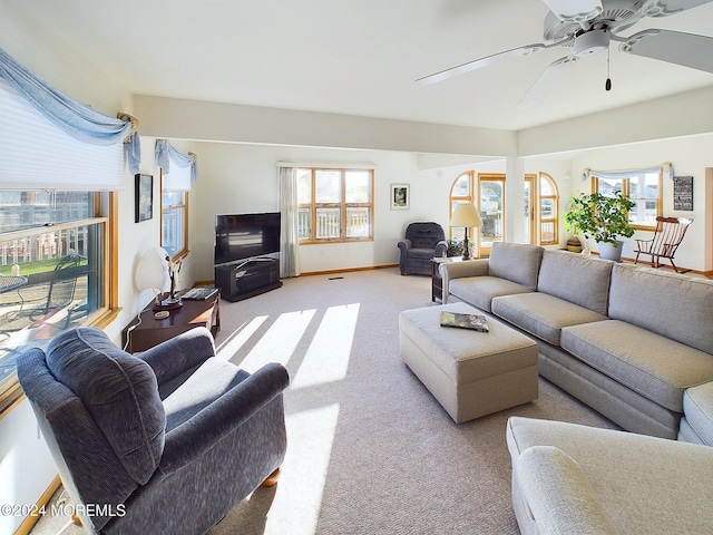 carpeted living room with a wealth of natural light and ceiling fan