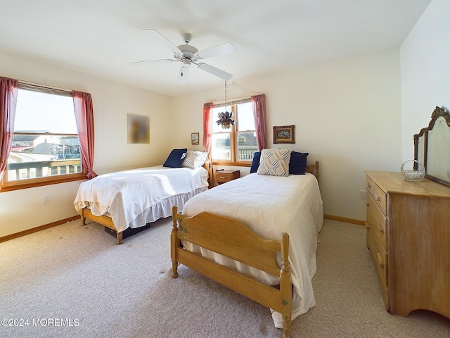 bedroom featuring ceiling fan and light carpet