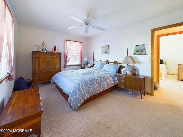 bedroom with ceiling fan and light carpet