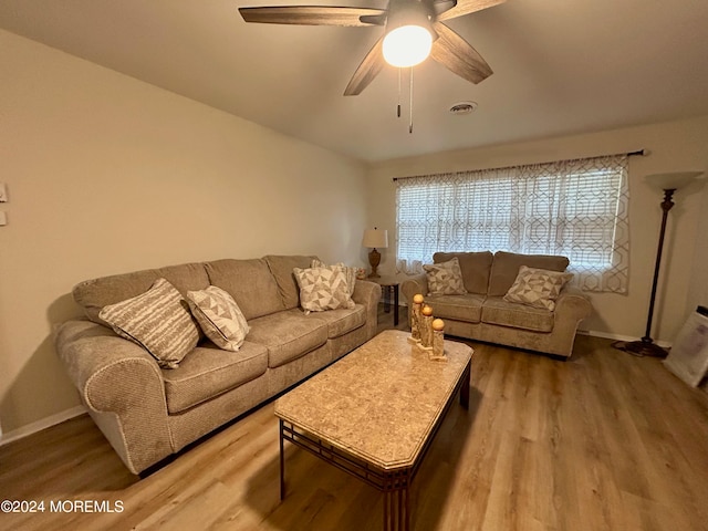 living room featuring ceiling fan and wood-type flooring