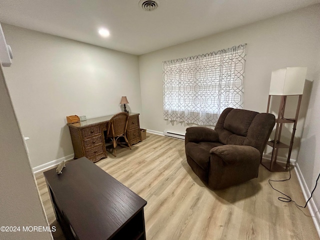 living area with baseboard heating and light wood-type flooring