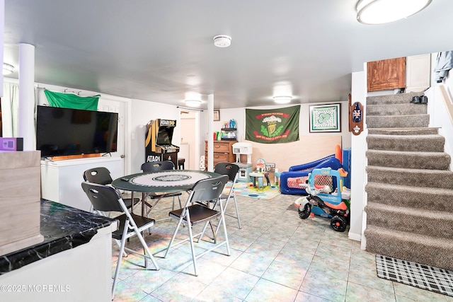 dining space with light tile patterned floors and stairway