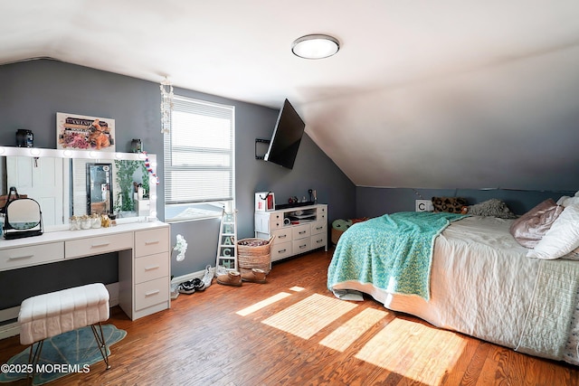 bedroom featuring vaulted ceiling and light wood-type flooring