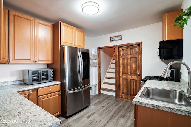 kitchen featuring a toaster, a sink, light wood-style floors, smart refrigerator, and black microwave