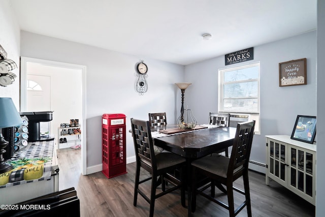 dining room featuring baseboards, dark wood-style floors, and a baseboard radiator