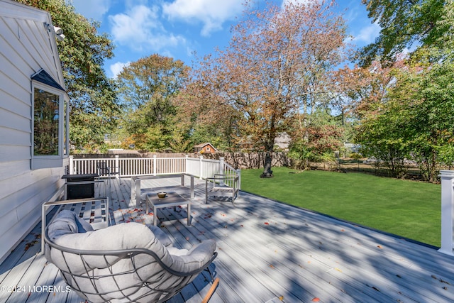 wooden terrace with a lawn