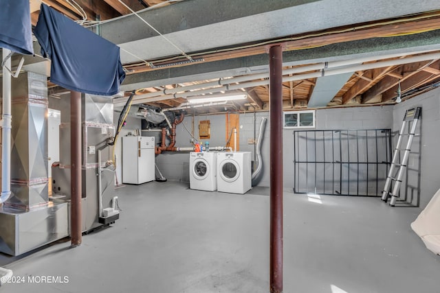 basement with washer and dryer and heating unit