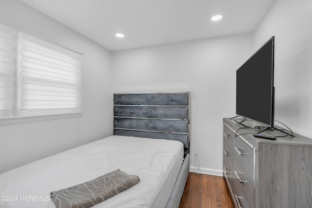 bedroom featuring dark hardwood / wood-style flooring