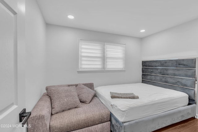 bedroom with hardwood / wood-style floors