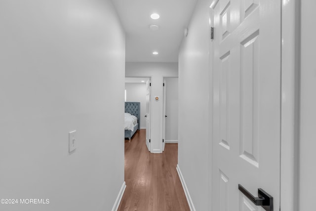 corridor with hardwood / wood-style floors