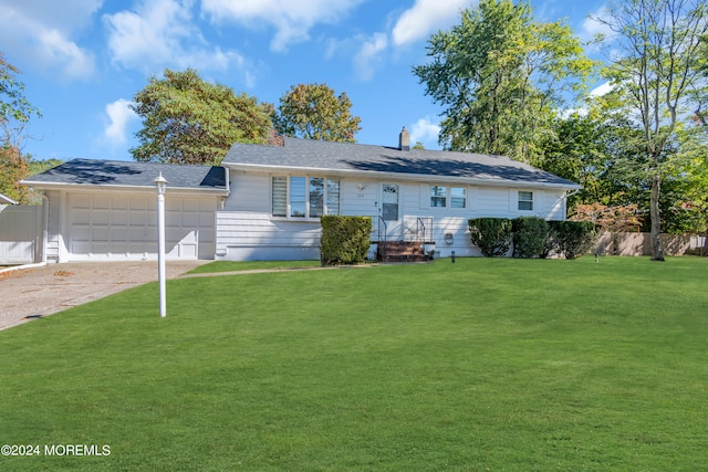 single story home featuring a front lawn and a garage