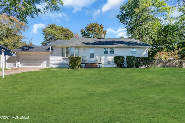 rear view of house featuring a yard and a garage