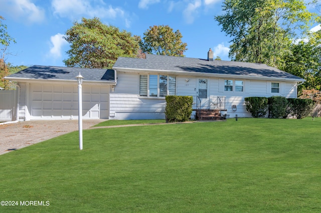 ranch-style house featuring a front yard and a garage