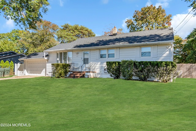 ranch-style home featuring a front yard and a garage