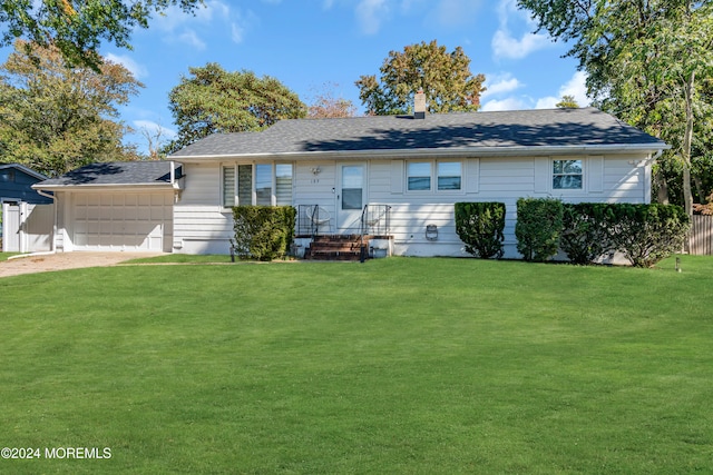 single story home featuring a front lawn and a garage