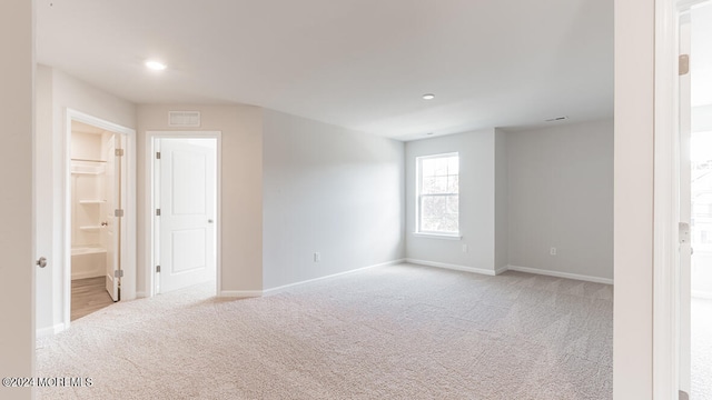 spare room with light carpet