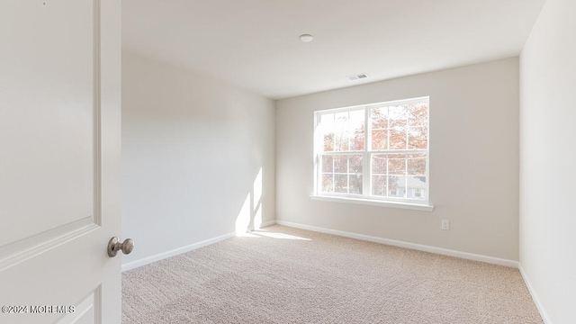 unfurnished room with light colored carpet