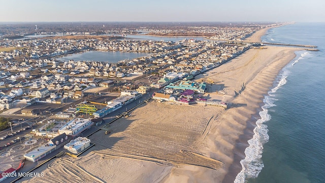 bird's eye view with a water view and a view of the beach