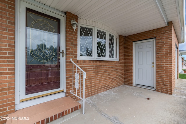 view of exterior entry featuring covered porch