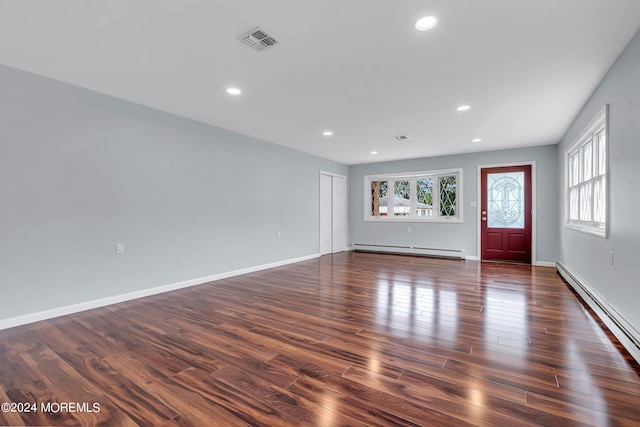 interior space featuring baseboard heating and dark hardwood / wood-style flooring