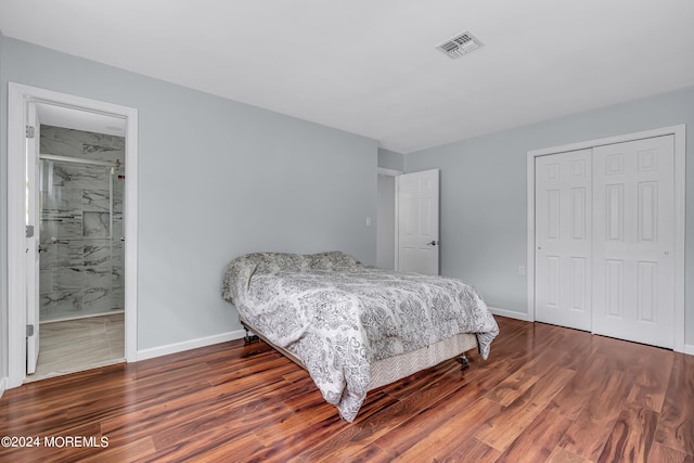 bedroom featuring connected bathroom, a closet, and dark hardwood / wood-style flooring