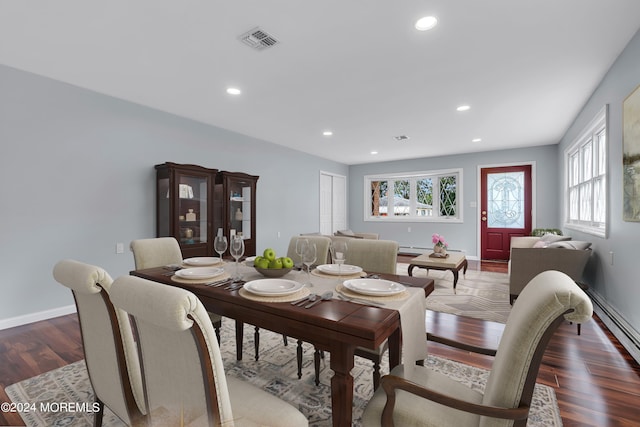 dining area with baseboard heating and dark hardwood / wood-style floors