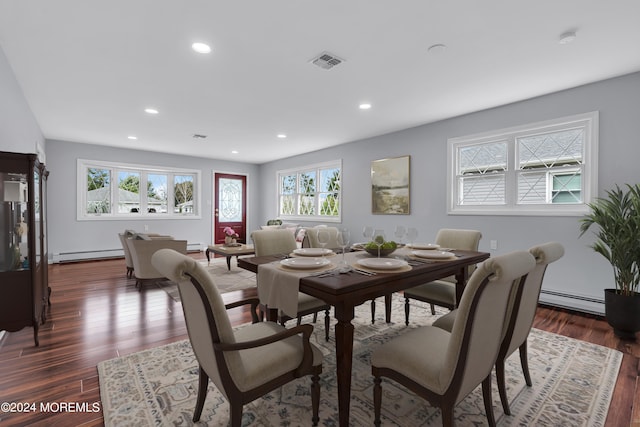 dining space with a baseboard radiator and dark wood-type flooring