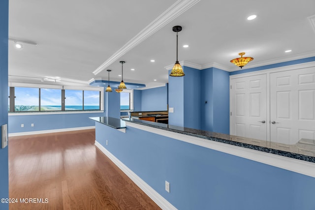 interior space with dark hardwood / wood-style floors, decorative light fixtures, and crown molding