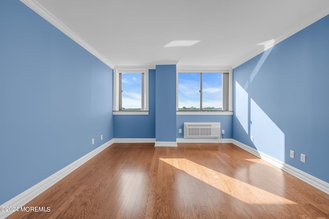 additional living space featuring hardwood / wood-style flooring and a wall mounted air conditioner