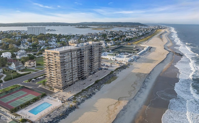 bird's eye view featuring a water view and a beach view