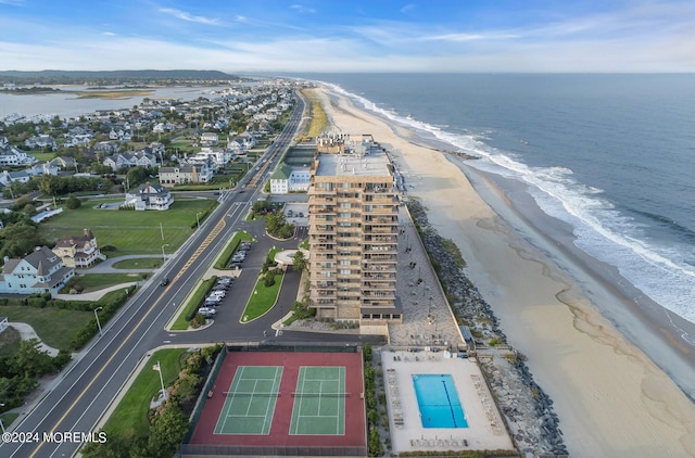 birds eye view of property featuring a beach view and a water view