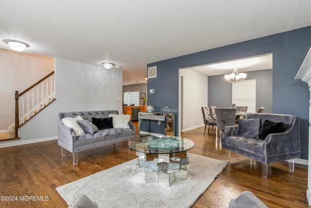 living room featuring a chandelier and dark hardwood / wood-style floors