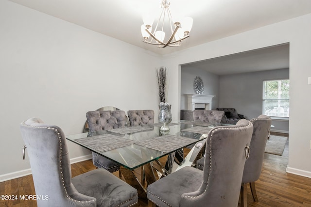 dining room with an inviting chandelier and dark wood-type flooring