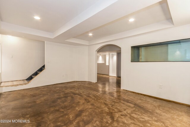 unfurnished room with a raised ceiling