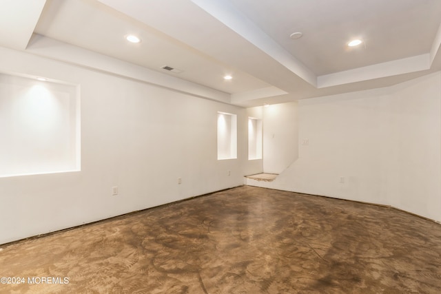 carpeted empty room featuring a tray ceiling