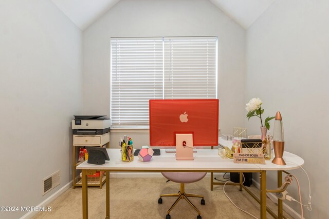 office area featuring light carpet and vaulted ceiling