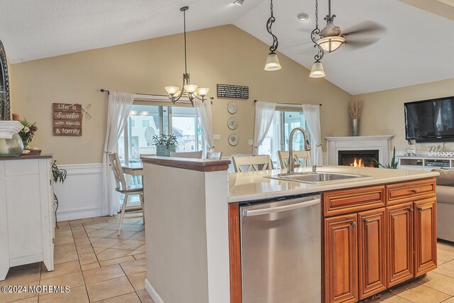 kitchen with a breakfast bar area, sink, lofted ceiling, light tile patterned floors, and stainless steel dishwasher