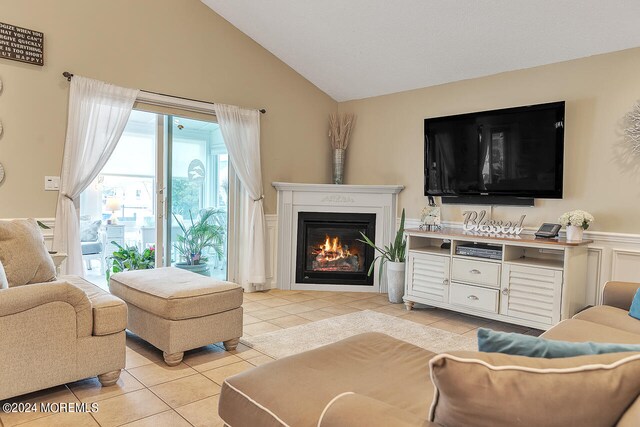 living room with vaulted ceiling and light tile patterned floors