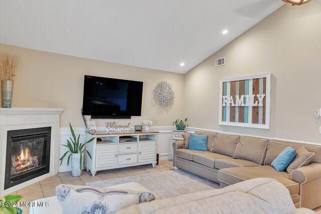 tiled living room featuring high vaulted ceiling