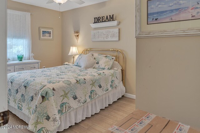 bedroom featuring light wood-type flooring and ceiling fan