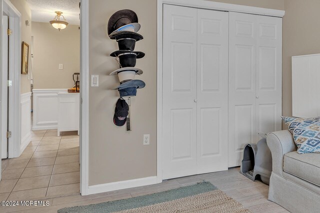 interior space with a textured ceiling and light wood-type flooring