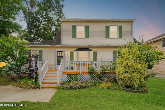 view of front of home with a lawn and a wooden deck