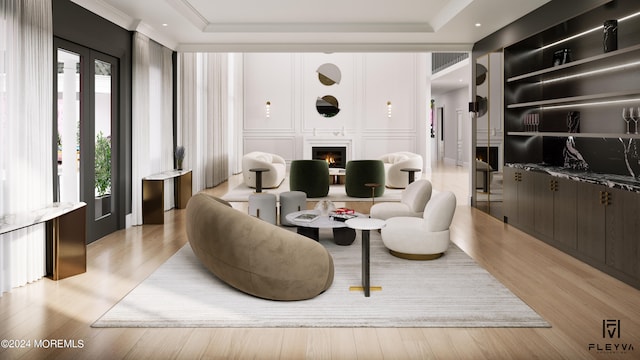 living room featuring a tray ceiling and light hardwood / wood-style floors