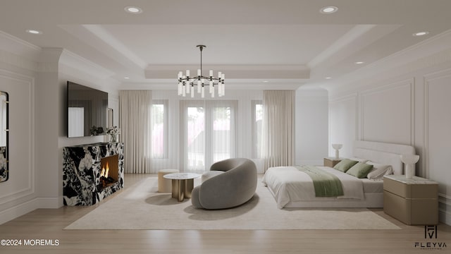 interior space featuring ornamental molding, a tray ceiling, light hardwood / wood-style flooring, and a chandelier