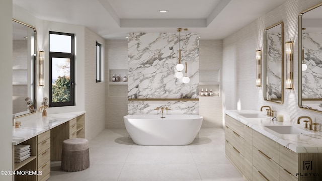 bathroom featuring tile walls, tile patterned flooring, a tray ceiling, a tub, and vanity