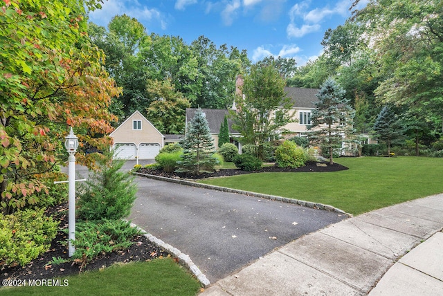 view of front of home with a front lawn and a garage