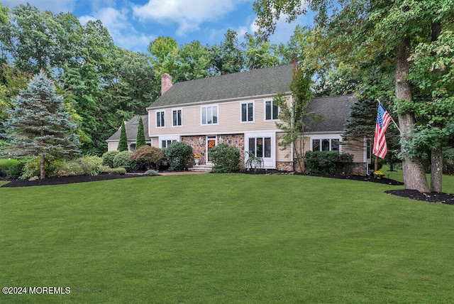 colonial home with a front lawn