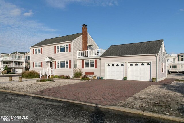 view of front of home with a balcony and a garage