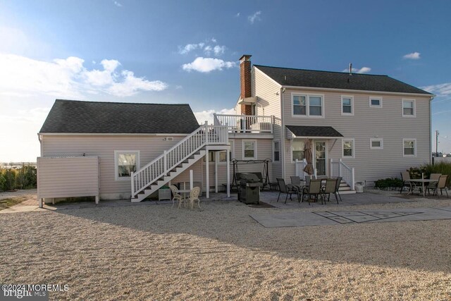 rear view of property featuring a patio area